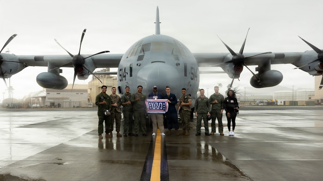 Vince Wilfork, center, former National Football League player, Super Bowl champion, and USO ambassador, and U.S. Marines assigned to Marine Air Refueler Transport Squadron 153, 1st Marine Aircraft WIng, pose for a group photo in front of a KC-130J during a visit to Marine Corps Base Hawaii, Feb. 10, 2026. Wilfork visited the installation as part of his mission to support and uplift service members and their families, using the opportunity to boost morale, strengthen community ties, and express his appreciation for Marines' dedication and sacrifice. (U.S. Marine Corps photo by Lance Cpl. Tania Guerrero)