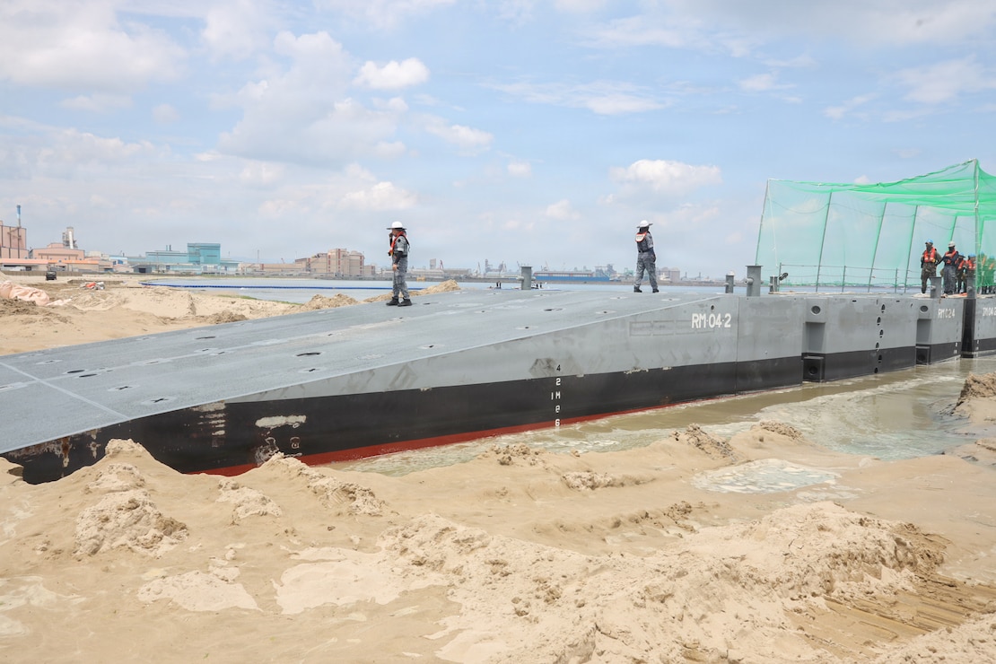 Republic of Korea service members aboard an Improved Navy Lighterage System conduct a beach stabbing of the platform during Combined Joint Logistics Over-the-Shore 26 at Dogu Beach, Pohang, South Korea, July 9, 2026. The offload was a Maritime Prepositioning Force exercise where 3rd Marine Logistics Group distributes equipment from a created port of entry and provides support to III Marine Expeditionary Force units training throughout South Korea, testing and validating 3rd MLG’s ability to conduct integrated logistics operations in complex environments. CJLOTS 26 is a combined exercise designed to integrate U.S. and Republic of Korea lighterage and ship-to-shore connector capabilities, improve combined readiness, strengthen the Republic of Korea-U.S. alliance, and expand combined maritime sustainment capacity during logistics operations. (U.S. Marine Corps photo by Lance Cpl. Matthew Borruso)