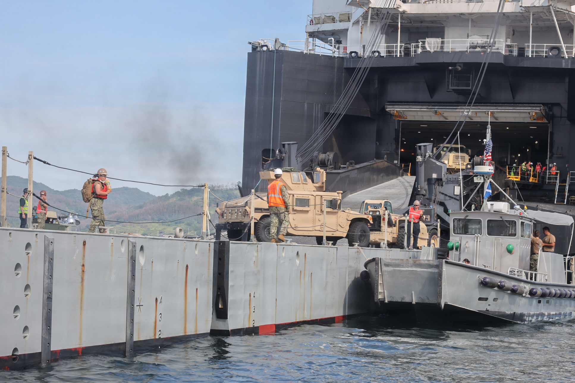 U.S. service members transfer a High Mobility Multipurpose Wheeled Vehicle onto an Improved Navy Lighterage System to conduct a cargo offload during Combined Joint Logistics Over-the-Shore 26 at Dogu Beach, Pohang, South Korea, July 9, 2026. The offload was a Maritime Prepositioning Force exercise where 3rd Marine Logistics Group distributes equipment from a created port of entry and provides support to III Marine Expeditionary Force units training throughout South Korea, testing and validating 3rd MLG’s ability to conduct integrated logistics operations in complex environments. CJLOTS 26 is a combined exercise designed to integrate U.S. and Republic of Korea lighterage and ship-to-shore connector capabilities, improve combined readiness, strengthen the Republic of Korea-U.S. alliance, and expand combined maritime sustainment capacity during logistics operations. (U.S. Marine Corps photo by Lance Cpl. Matthew Borruso)