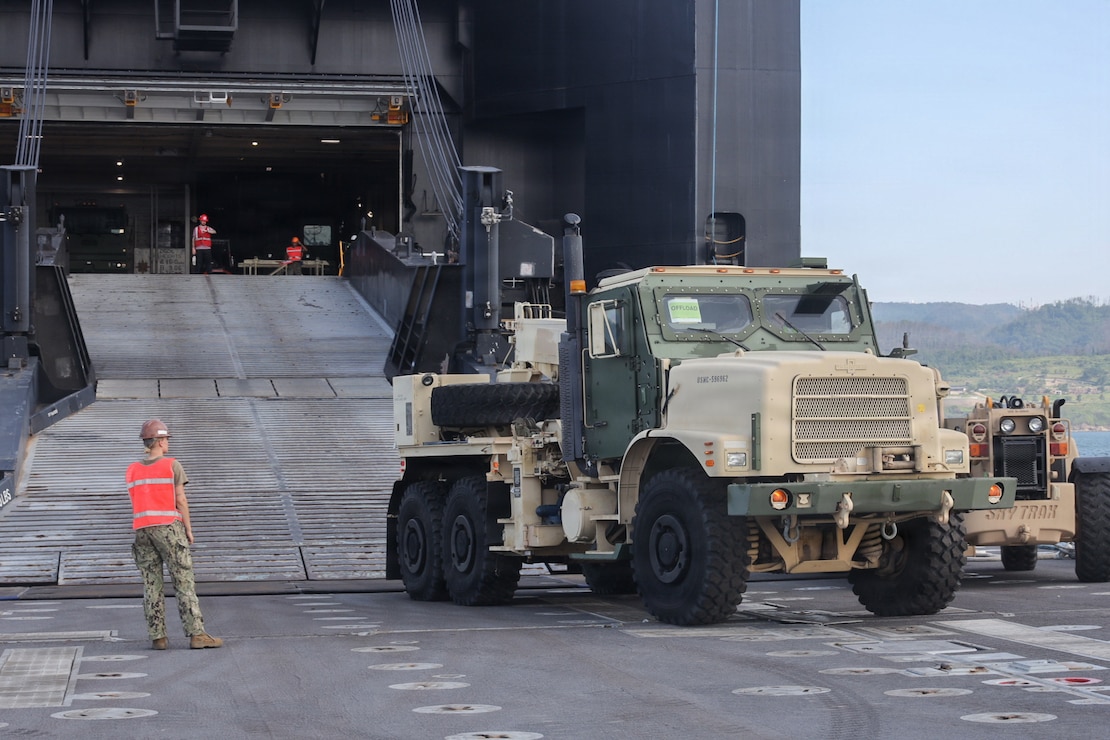 U.S. service members transfer a MK36 Medium Tactical Replacement Vehicle Wrecker onto an Improved Navy Lighterage System to conduct a cargo offload during Combined Joint Logistics Over-the-Shore 26 at Dogu Beach, Pohang, South Korea, July 9, 2026. The offload was a Maritime Prepositioning Force exercise where 3rd Marine Logistics Group distributes equipment from a created port of entry and provides support to III Marine Expeditionary Force units training throughout South Korea, testing and validating 3rd MLG’s ability to conduct integrated logistics operations in complex environments. CJLOTS 26 is a combined exercise designed to integrate U.S. and Republic of Korea lighterage and ship-to-shore connector capabilities, improve combined readiness, strengthen the Republic of Korea-U.S. alliance, and expand combined maritime sustainment capacity during logistics operations. (U.S. Marine Corps photo by Lance Cpl. Matthew Borruso)
