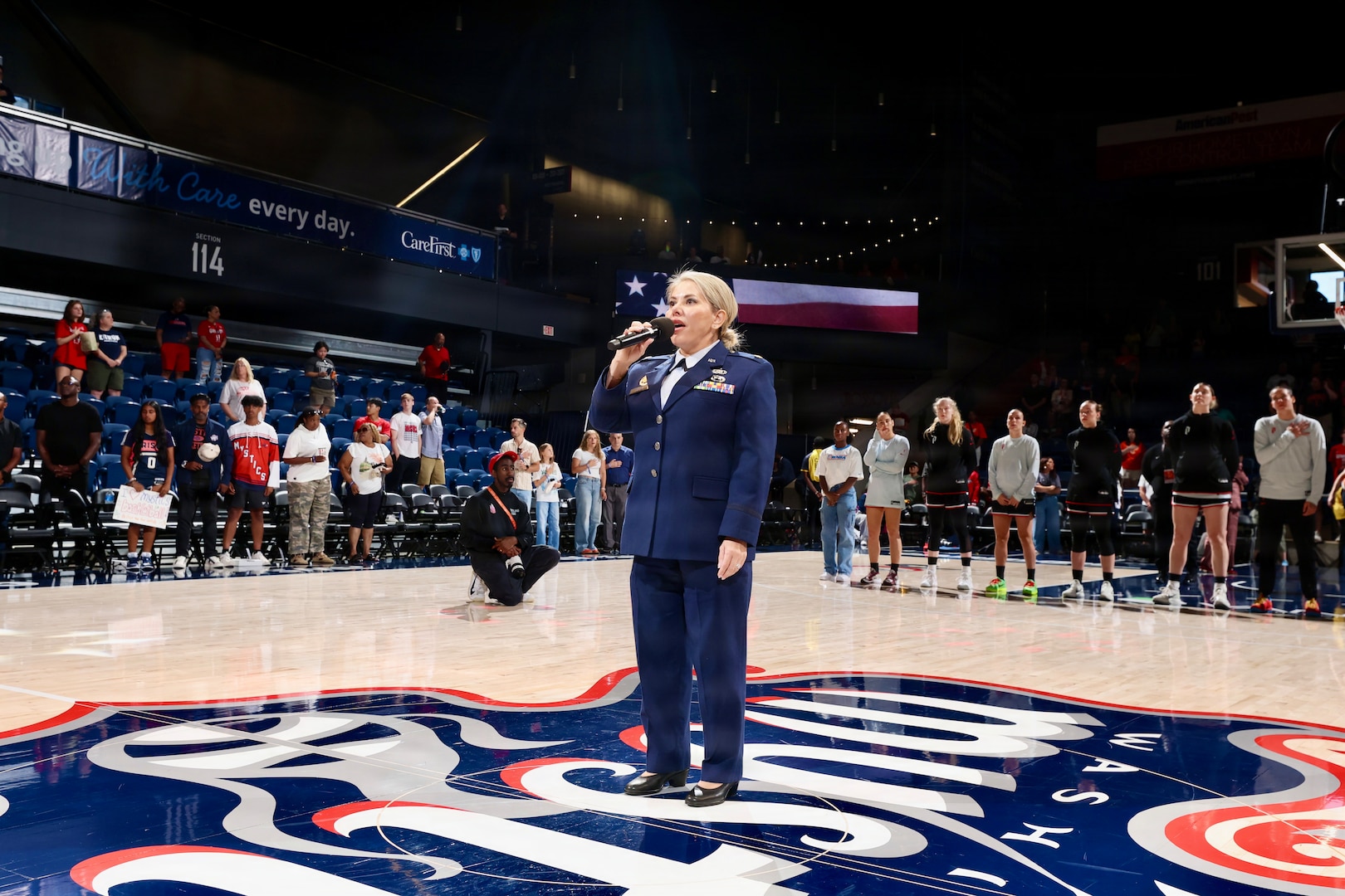 U.S. Air Force Maj. Karen Fraley-Deegan, Military Personnel Management Officer, 113th Wing, District of Columbia Air National Guard, performs the National Anthem during pregame ceremonies before a Washington Mystics game at CareFirst Arena, July 16, 2026. Fraley-Deegan has performed the National Anthem at promotions, retirements, change of command ceremonies, inter-service transfers, military commemorations, and civic events, using her voice to honor those who serve, strengthen esprit de corps, and tell the nation's story through song.