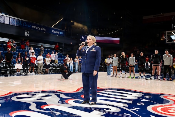 U.S. Air Force Maj. Karen Fraley-Deegan, Military Personnel Management Officer, 113th Wing, District of Columbia Air National Guard, performs the National Anthem during pregame ceremonies before a Washington Mystics game at CareFirst Arena, July 16, 2026. Fraley-Deegan has performed the National Anthem at promotions, retirements, change of command ceremonies, inter-service transfers, military commemorations, and civic events, using her voice to honor those who serve, strengthen esprit de corps, and tell the nation's story through song.