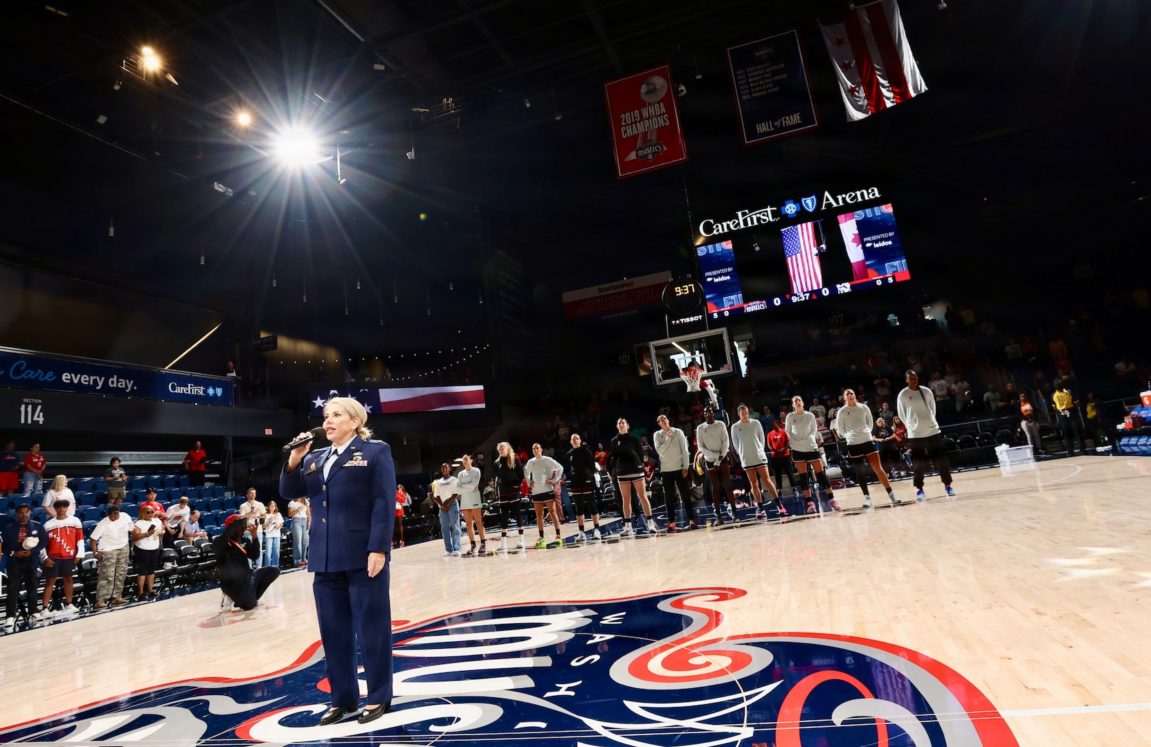 U.S. Air Force Maj. Karen Fraley-Deegan, Military Personnel Management Officer, 113th Wing, District of Columbia Air National Guard, performs the National Anthem during pregame ceremonies before a Washington Mystics game at CareFirst Arena, July 16, 2026. Fraley-Deegan has performed the National Anthem at promotions, retirements, change of command ceremonies, inter-service transfers, military commemorations, and civic events, using her voice to honor those who serve, strengthen esprit de corps, and tell the nation's story through song.