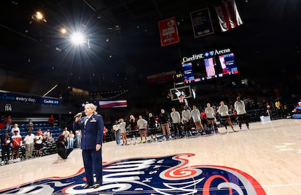 U.S. Air Force Maj. Karen Fraley-Deegan, Military Personnel Management Officer, 113th Wing, District of Columbia Air National Guard, performs the National Anthem during pregame ceremonies before a Washington Mystics game at CareFirst Arena, July 16, 2026. Fraley-Deegan has performed the National Anthem at promotions, retirements, change of command ceremonies, inter-service transfers, military commemorations, and civic events, using her voice to honor those who serve, strengthen esprit de corps, and tell the nation's story through song.