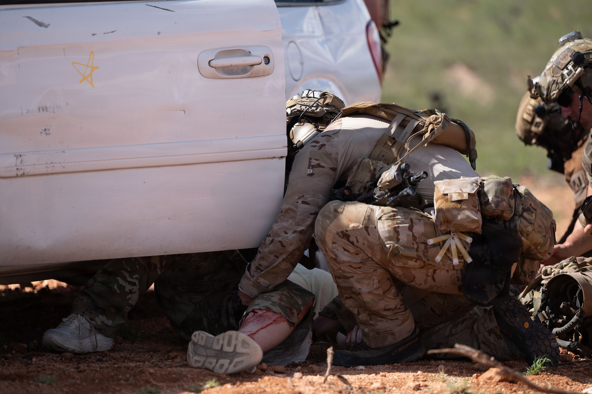 A U.S. Air Force pararescueman assigned to the 38th Rescue Squadron provides medical treatment to a simulated patient during Operation Iron Covenant, a training exercise near Benson, Arizona, July 22, 2026. Operation Iron Covenant is designed to evaluate the readiness of rescue teams tasked with recovering isolated personnel in contested environments while reinforcing the coordination and decision-making required during combat rescue operations. (U.S. Air Force photo by Airman Najzee Kuzu)