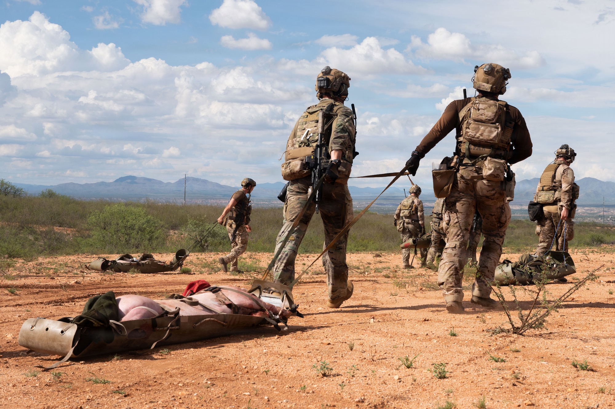 U.S. Air Force pararescuemen assigned to the 38th Rescue Squadron drag a simulated casualty to safety during Operation Iron Covenant, a training exercise near Benson, Arizona, July 22, 2026. The exercise simulated real-world scenarios as part of pre-deployment training and required extreme composure and accuracy in order to perform life-saving measures. (U.S. Air Force photo by Airman Najzee Kuzu)
