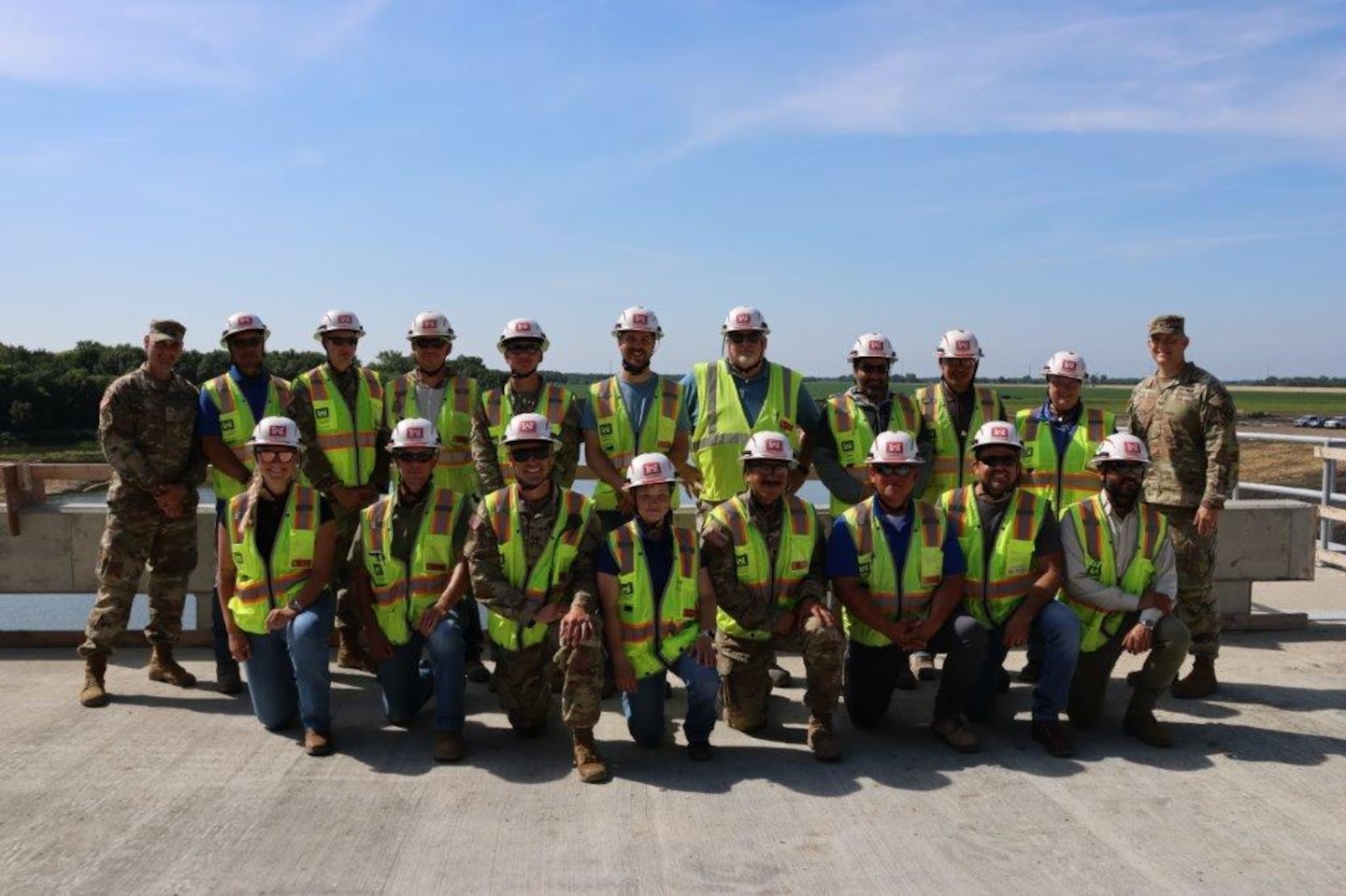 people in a group, wearing high vis gear, military uniforms