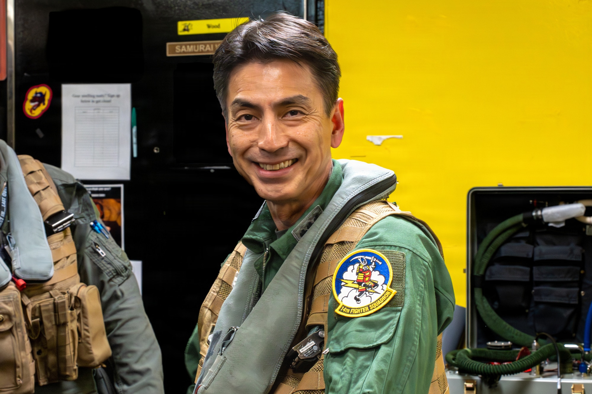 Japan Air Self-Defense Force Lt. Gen. Keita Funakura, Northern Air Defense Force commander, smiles after receiving a unit patch before a USAF F-16 Fighting Falcon familiarization flight at Misawa Air Base, Japan, July 27, 2026.