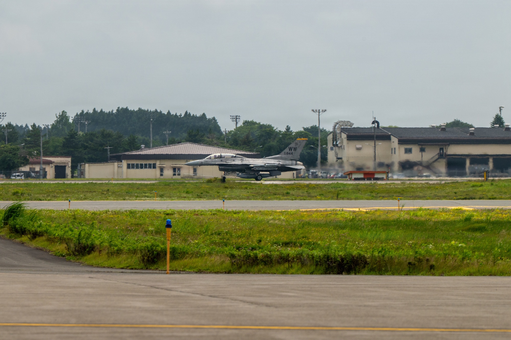A U.S. Air Force F-16 Fighting Falcon taxis on a flightline before a familiarization flight carrying Japan Air Self-Defense Force Lt. Gen. Keita Funakura, Northern Air Defense Force commander, and USAF Col. Jeromy Guinther, 35th Operations Group commander, at Misawa Air Base, Japan, July 27, 2026.