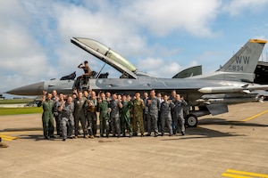 U.S. Air Force members assigned to the 35th Fighter Wing, Japan Air Self-Defense Force members and Japan Ground Self-Defense Force members pose for a group photo following a USAF F-16 Fighting Falcon familiarization flight at Misawa Air Base, Japan, July 27, 2026.