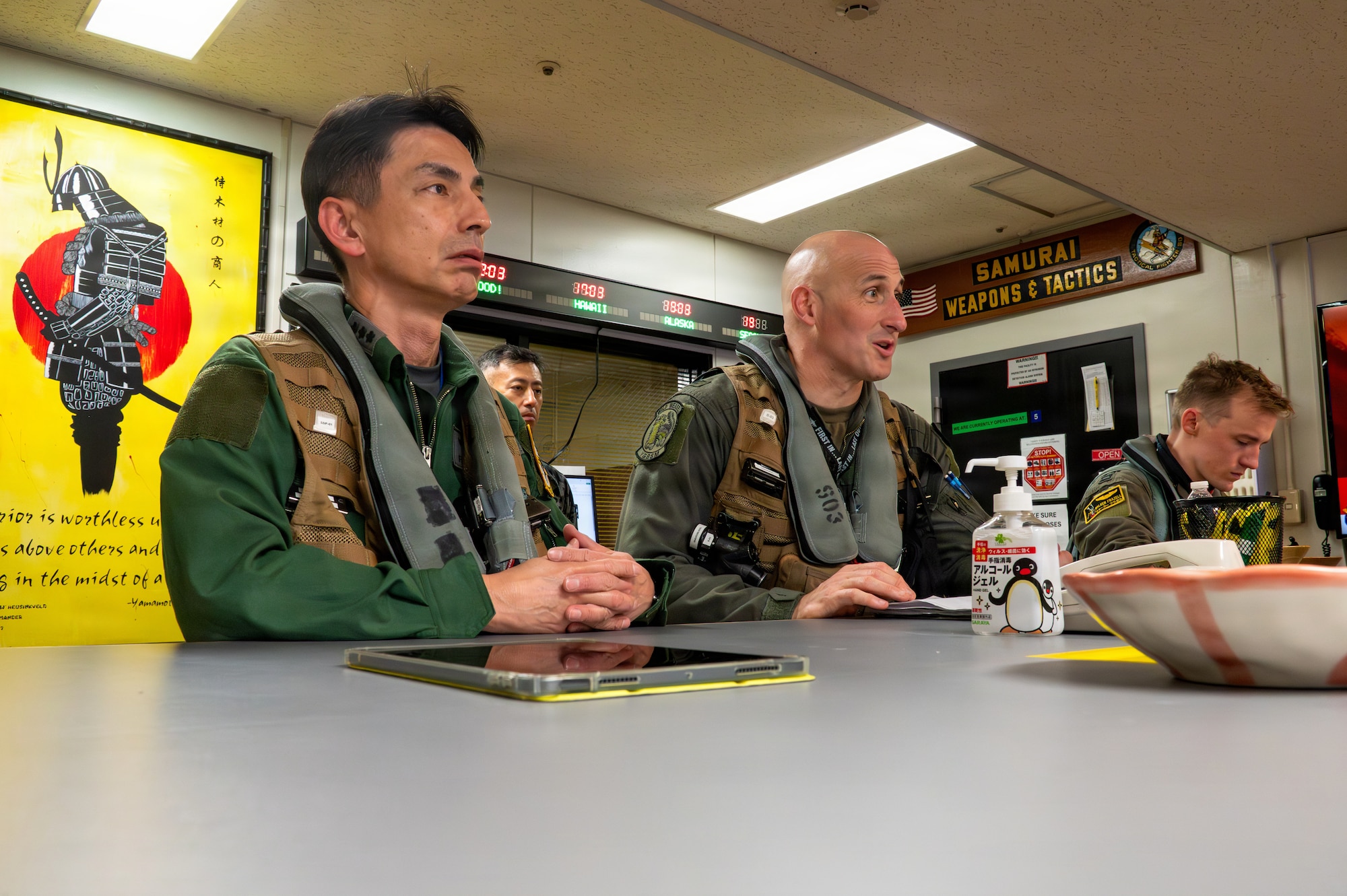U.S. Air Force Col. Jeromy Guinther, center, 35th Operations Group commander and Japan Air Self-Defense Force Lt. Gen. Keita Funakura, Northern Air Defense Force commander, receive a flight briefing before a USAF F-16 Fighting Falcon familiarization flight at Misawa Air Base, Japan, July 27, 2026.