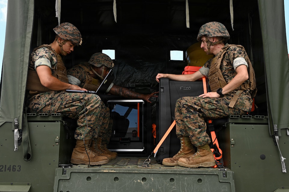 U.S. Marines with Intermediate Repair Company, 3rd Maintenance Battalion, 3rd Marine Logistics Group, prepare to test print on-the-move capabilities during Valiant Shield 26 on Camp Kinser, Okinawa, Japan, June 22, 2026. IRC Marines participated in Resilient Advanced Manufacturing for Contested Environments, or RAMFORCE, an initiative hosted by the Office of the Under Secretary of Defense for Research and Engineering. The innovative event brought together military personnel, government laboratories, and private industry to evaluate how advanced manufacturing technologies could enable expeditionary forces to repair, replace and even produce critical equipment at the point of need. (U.S. Marine Corps photo by Cpl. Rachel Mason)