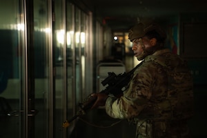 U.S. Air Force Tech. Sgt. Cedrick Neal, 374th Security Forces Squadron flight sergeant, scans a room for potential threats during a simulated active shooter exercise.