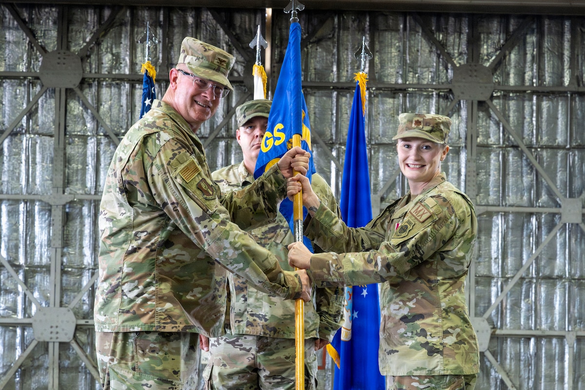 U.S. Air Force Col. Kenneth Beebe, left, 35th Maintenance Group commander, and Maj. Sophia Rizzo, 14th Fighter Generation Squadron commander, retire the 14th FGS guidon during the 35th AMXS activation ceremony at Misawa Air Base Japan, July 17, 2026.