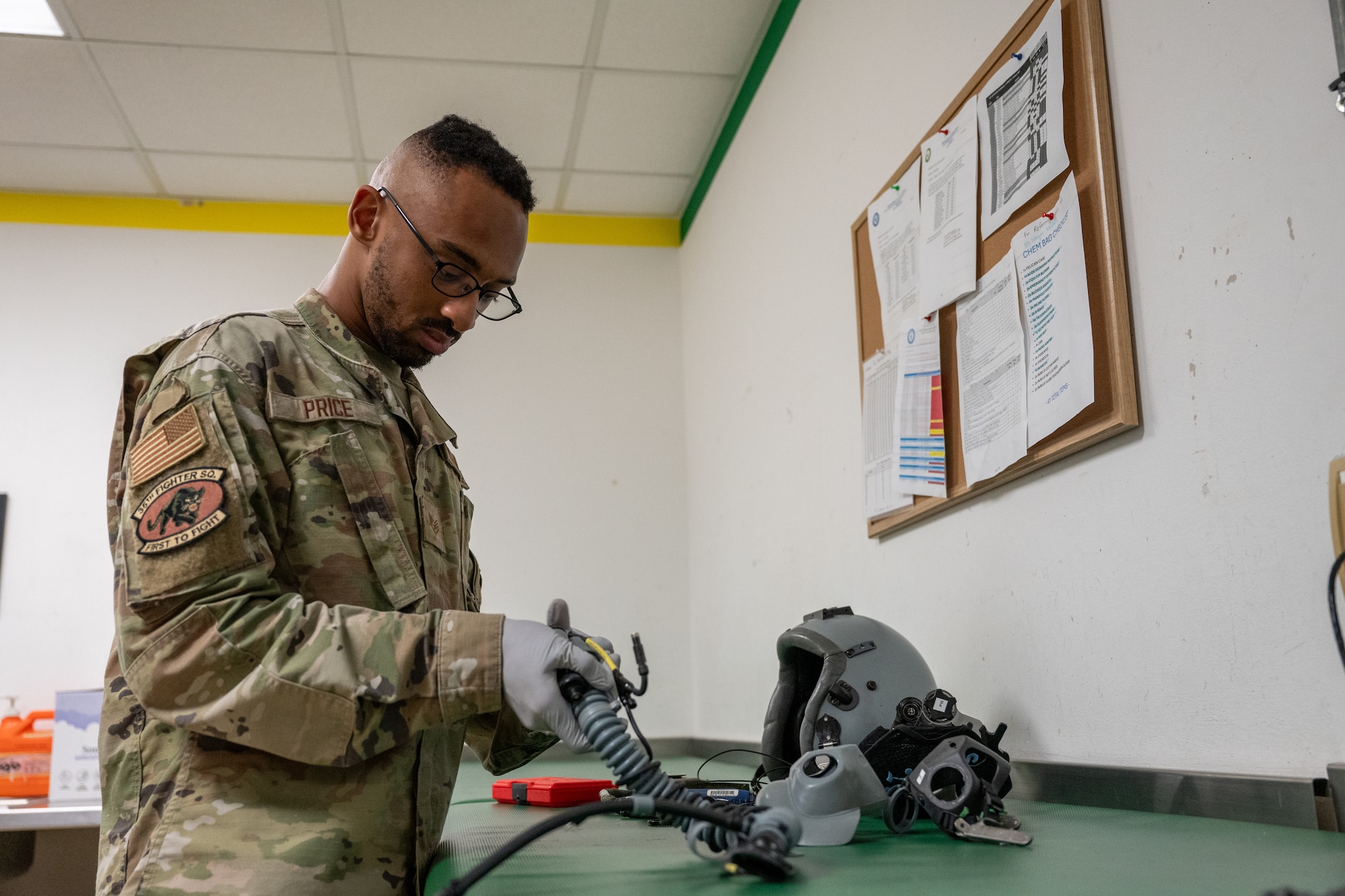 An Airman inspects an oxygen mask.