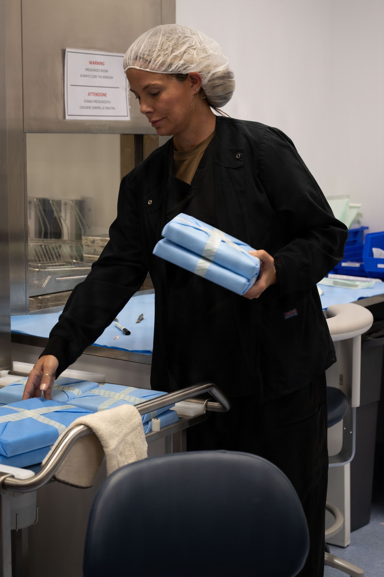 A dental technician organizes equipment.