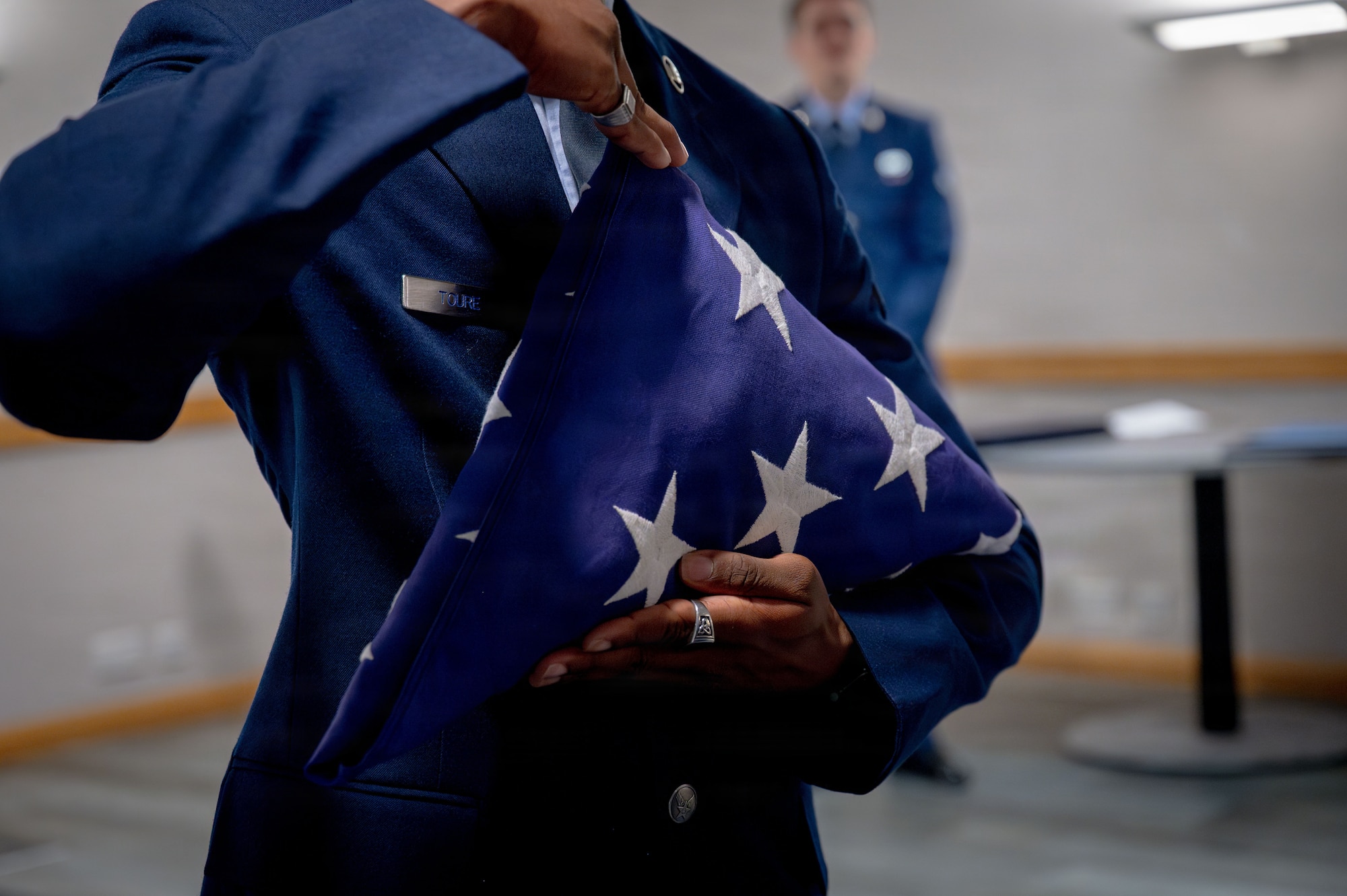 A Team Mildenhall Honor Guardsman folds a flag during a retirement ceremony at RAF Mildenhall, England, July 9, 2026.