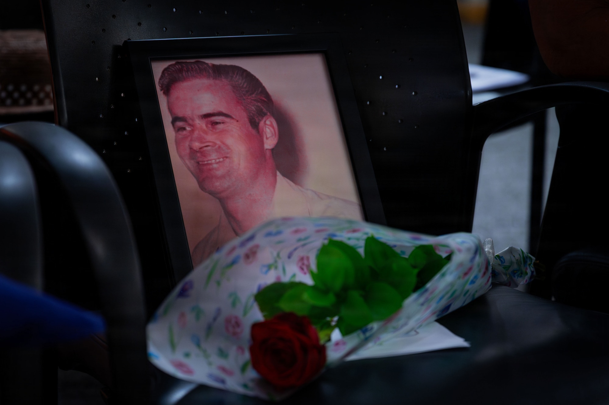A photo of Air Force Staff Sgt. Lawrence Cherry is displayed during a retirement ceremony for his son, U.S. Air Force Master Sgt. Jonathan Cherry, at RAF Mildenhall, England, July 9, 2026.