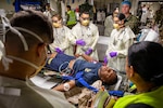 Sailors assigned to the Expeditionary Medical Unit (EMU-2) evaluate a simulated casualty during the unit’s Operational Readiness Evaluation (ORE) aboard the expeditionary fast transport ship USNS Point Loma (T-EPF 15), July 25, 2026. The event marked the Navy’s first ORE conducted for an EMU, and the first afloat ORE for the Navy’s expeditionary medical capability, a critical step in validating deployable medical capabilities in support of maritime operations, distributed maritime operations, and warfighter readiness. (U.S. Navy photo by Mass Communication Specialist 1st Class Nathan T. Beard)