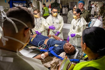 Sailors assigned to the Expeditionary Medical Unit (EMU-2) evaluate a simulated casualty during the unit’s Operational Readiness Evaluation (ORE) aboard the expeditionary fast transport ship USNS Point Loma (T-EPF 15), July 25, 2026. The event marked the Navy’s first ORE conducted for an EMU, and the first afloat ORE for the Navy’s expeditionary medical capability, a critical step in validating deployable medical capabilities in support of maritime operations, distributed maritime operations, and warfighter readiness. (U.S. Navy photo by Mass Communication Specialist 1st Class Nathan T. Beard)