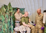 Hospital Corpsman 1st Class James C. Radecki (left), assigned to Navy Medicine Readiness and Training Command Twentynine Palms, treats Lance Cpl. Liam Jackson (center) at the Consolidated Aid Station (CAS) during Integrated Training Exercise (ITX) 3-26 at Camp Wilson aboard Marine Air-Ground Task Force Training Command/Marine Corps Air Ground Combat Center Twentynine Palms. ITX is the Marine Forces Reserve's premier live-fire combined arms exercise, preparing Marine Air-Ground Task Forces for operational readiness in realistic combat environments. (U.S. Navy photo by Christopher Jones, NH/NMRTC Twentynine Palms public affairs officer).