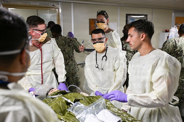 Cmdr. Christian Esquivel, officer-in-charge, Expeditionary Medical Unit Two, serves as the casualty receiving officer for a simulated casualty during the unit’s Operational Readiness Evaluation (ORE) aboard the expeditionary fast transport ship USNS Point Loma (T-EPF 15), July 25, 2026. The event marked the U.S. Navy’s first ORE conducted for an EMU, and the first afloat ORE for the U.S. Navy’s expeditionary medical capability, a critical step in validating deployable medical capabilities in support of maritime operations, distributed maritime operations, and warfighter readiness. (U.S. Navy photo by Mass Communication Specialist 1st Class Shayla D. Hamilton)