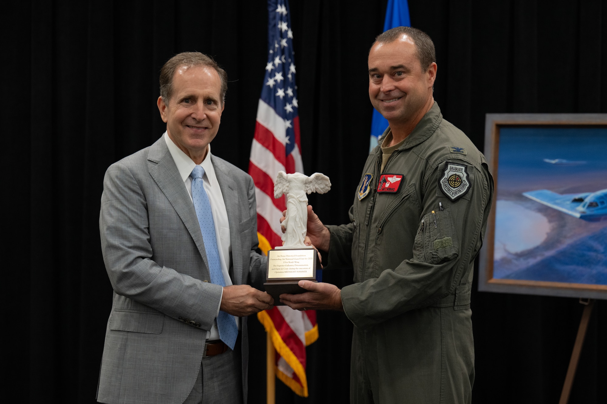 Retired Gen. James Slife, former vice chief of staff of the Air Force, left, presents Air National Guard Col. Matthew Howard, 131st Bomb Wing commander, with the Air Force Historical Foundation's 2025 Air National Guard Award for Superior Unit Performance at Whiteman Air Force Base, Missouri, July 28, 2026. The award recognizes the teamwork, innovation and operational excellence that culminated in Operation Midnight Hammer. (U.S. Air Force photo by Senior Airman Matthew S. Domingos)