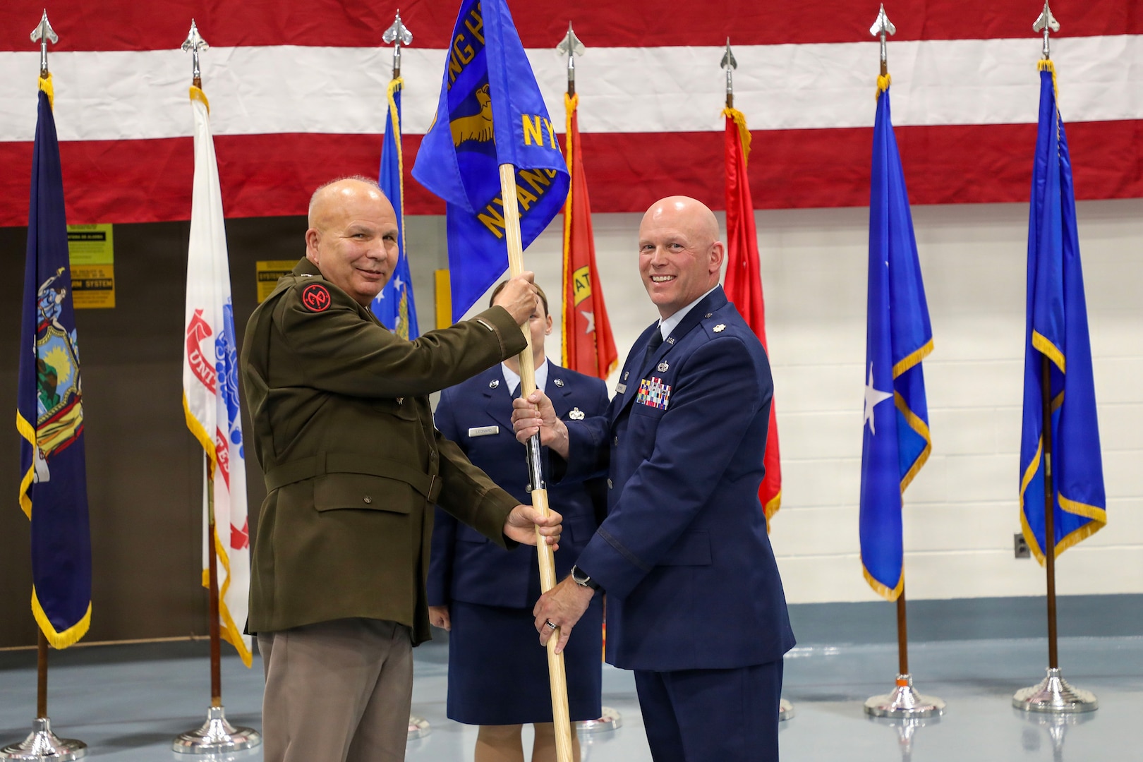 Army Maj. Gen. Ray Shields, the adjutant general of the New York National Guard, passes the guidon of the New York Air National Guard Recruiting and Retention Squadron to Maj. Josh Bowers, the new squadron's commander during the squadron activation ceremony held at the New York National Guard headquarters in Latham, N.Y., July 29, 2026.