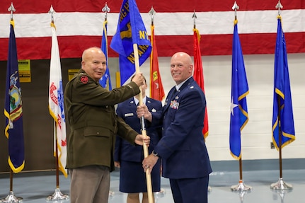 Army Maj. Gen. Ray Shields, the adjutant general of the New York National Guard, passes the guidon of the New York Air National Guard Recruiting and Retention Squadron to Maj. Josh Bowers, the new squadron's commander during the squadron activation ceremony held at the New York National Guard headquarters in Latham, N.Y., July 29, 2026.