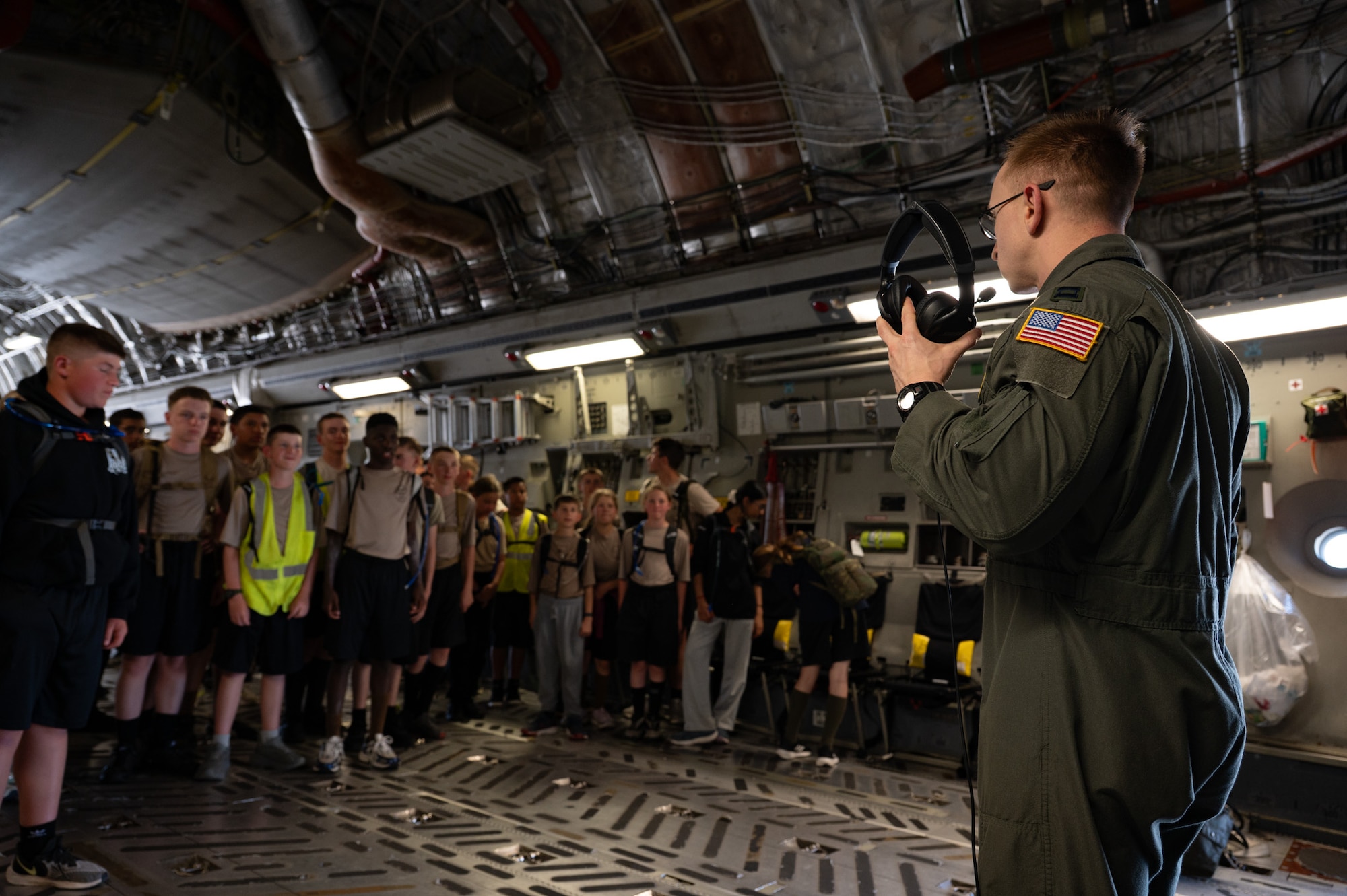 U.S. Air Force Capt. Brian Colitti, Air Mobility Command Test and Evaluation Squadron command test director, introduces himself to New York Wing Civil Air Patrol Encampment cadets at Hancock Field Air National Guard Base, N.Y., July 23, 2026. Colitti and aircrew assigned to the 6th Airlift Squadron provided a static display to demonstrate the C-17 Globemaster III’s capabilities and inspire future generations of Airmen. (U.S. Air Force photo by Airman 1st Class Haeleigh Bayle)