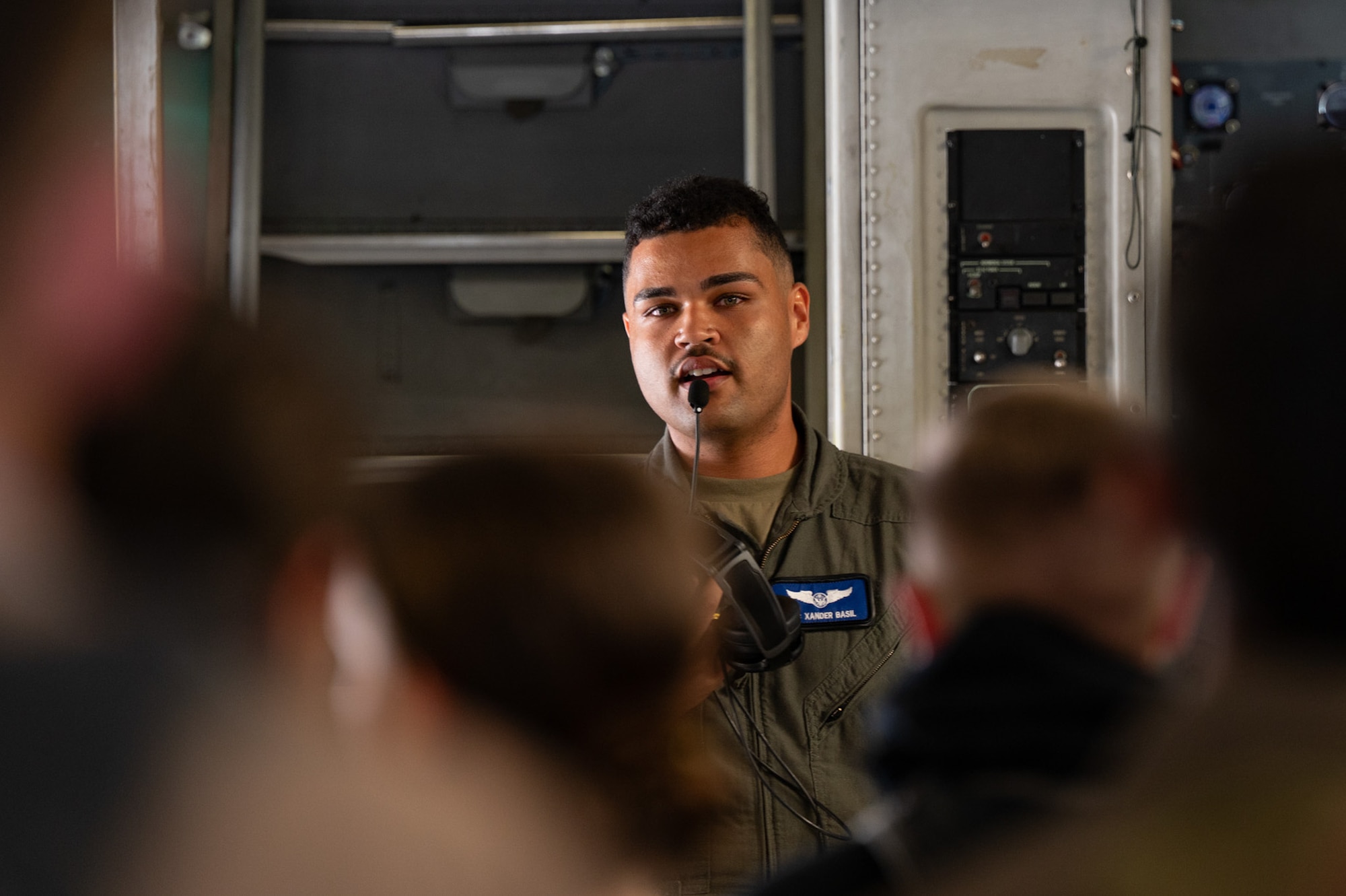 U.S. Air Force Airman 1st Class Xander Basil, 6th Airlift Squadron loadmaster, explains the C-17 Globemaster III’s mission capabilities to New York Wing Civil Air Patrol Encampment cadets at Hancock Field Air National Guard Base, N.Y., July 23, 2026. Basil explained what his job entails and demonstrated different C-17 features. (U.S. Air Force photo by Airman 1st Class Haeleigh Bayle)