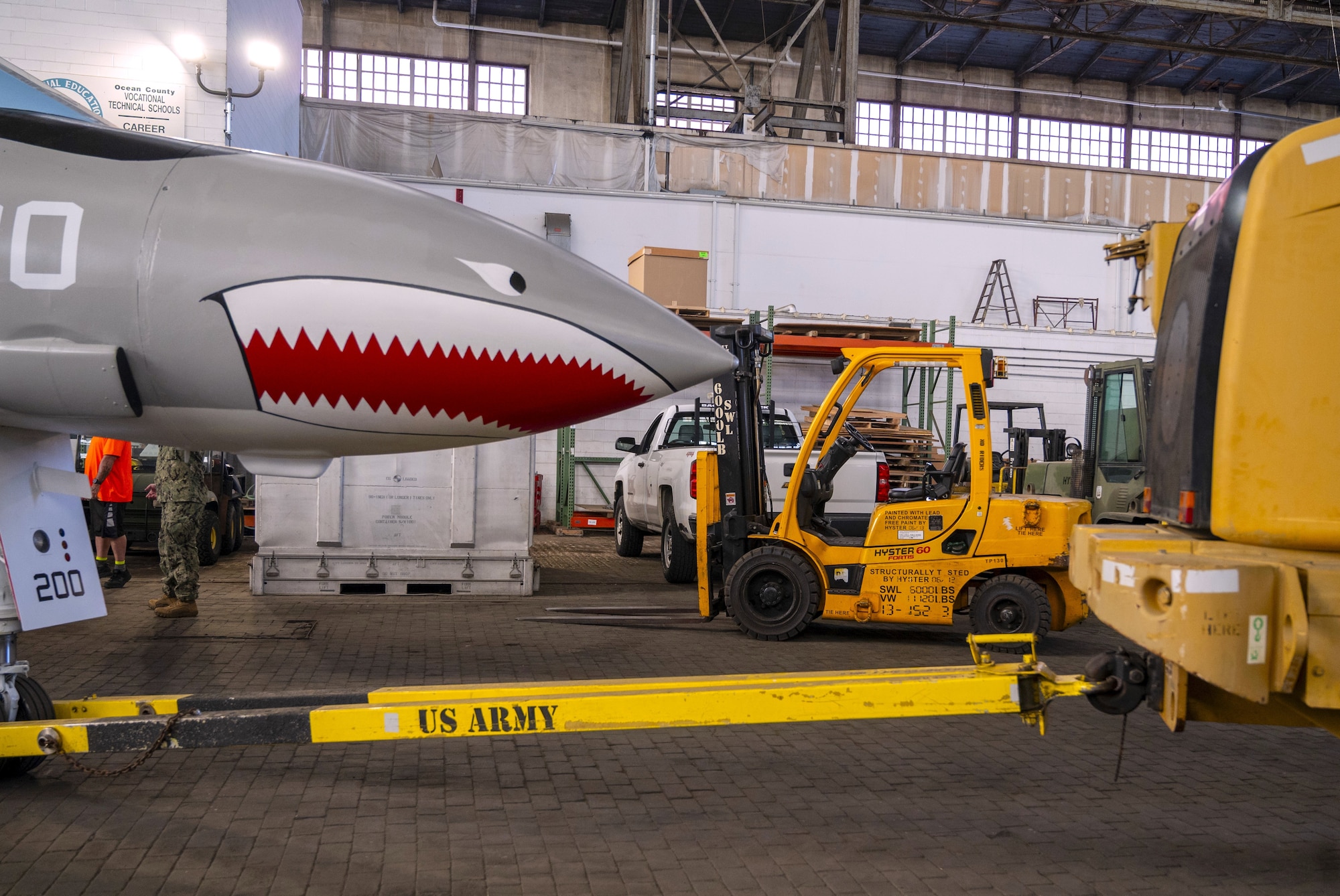 A newly restored F-4 Phantom II is hooked to a transport vehicle in Hangar 1 to be moved to its new location as a static display in Navy Lakehurst Air Park at Joint Base McGuire-Dix-Lakehurst, N.J., July 1, 2026. The restoration, which took a team of volunteers 13 months to complete, included sheet metal and canopy repair, sanding the aircraft from the top down, and application of paint, lettering, insignia and clear coating for long-lasting preservation. (U.S. Air Force photo by Susan Moriarty)