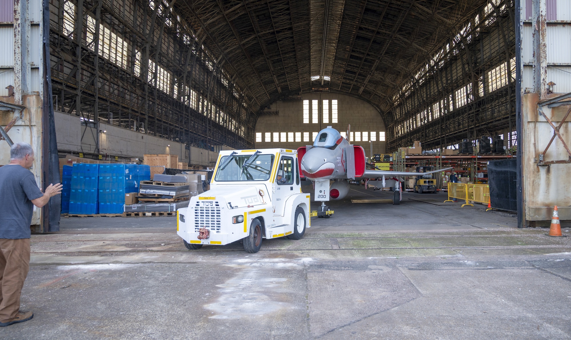 Volunteers transport a newly restored F-4 Phantom II military aircraft out of Hangar 1 to its new location as a static display in Navy Lakehurst Air Park at Joint Base McGuire-Dix-Lakehurst, N.J., July 1, 2026. The restoration, which took a team of volunteers 13 months to complete, included sheet metal and canopy repair, sanding the aircraft from the top down, and application of paint, lettering, insignia and clear coating for long-lasting preservation. (U.S. Air Force photo by Susan Moriarty)