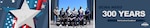 A group poses for a photo in front of a war memorial