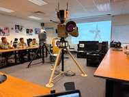 Soldiers and Airmen from the Washington National Guard's 10th Civil Support Team receive a briefing on an advanced counter-unmanned aircraft systems at their office at Camp Murray, Washington, June 23, 2026.