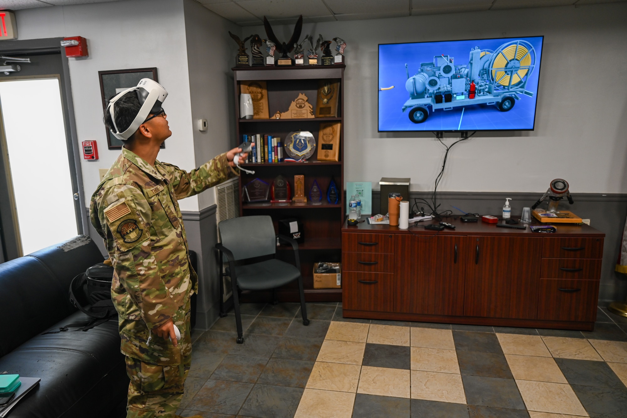 An Airman points at a television with virtual reality gear. (U.S. Air Force photo by Airman 1st Class Donnell Ramsey)
