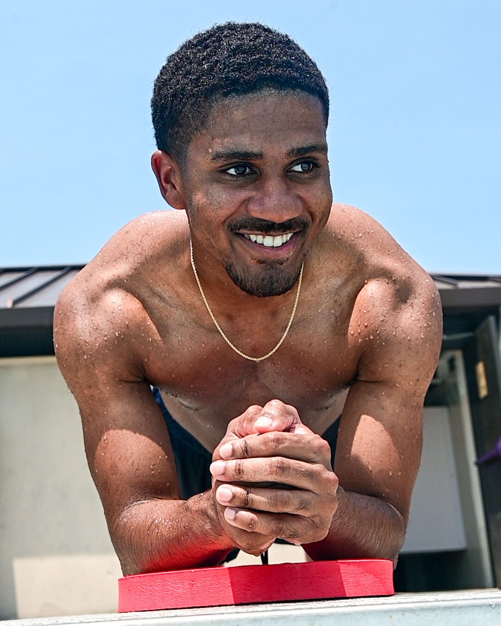 U.S. Air Force Airman 1st Class Malachi Reape, 436th Health Care Operations Squadron medical technician, performs a plank hold during a Dover Duties visit to the Oasis Pool at Dover Air Force Base, Delaware, July 15, 2026. Reape and the 436th Airlift Wing command team toured the recreational facility and participated in a Tactical Water Aerobics class. (U.S. Air Force photo by Mauricio Campino)