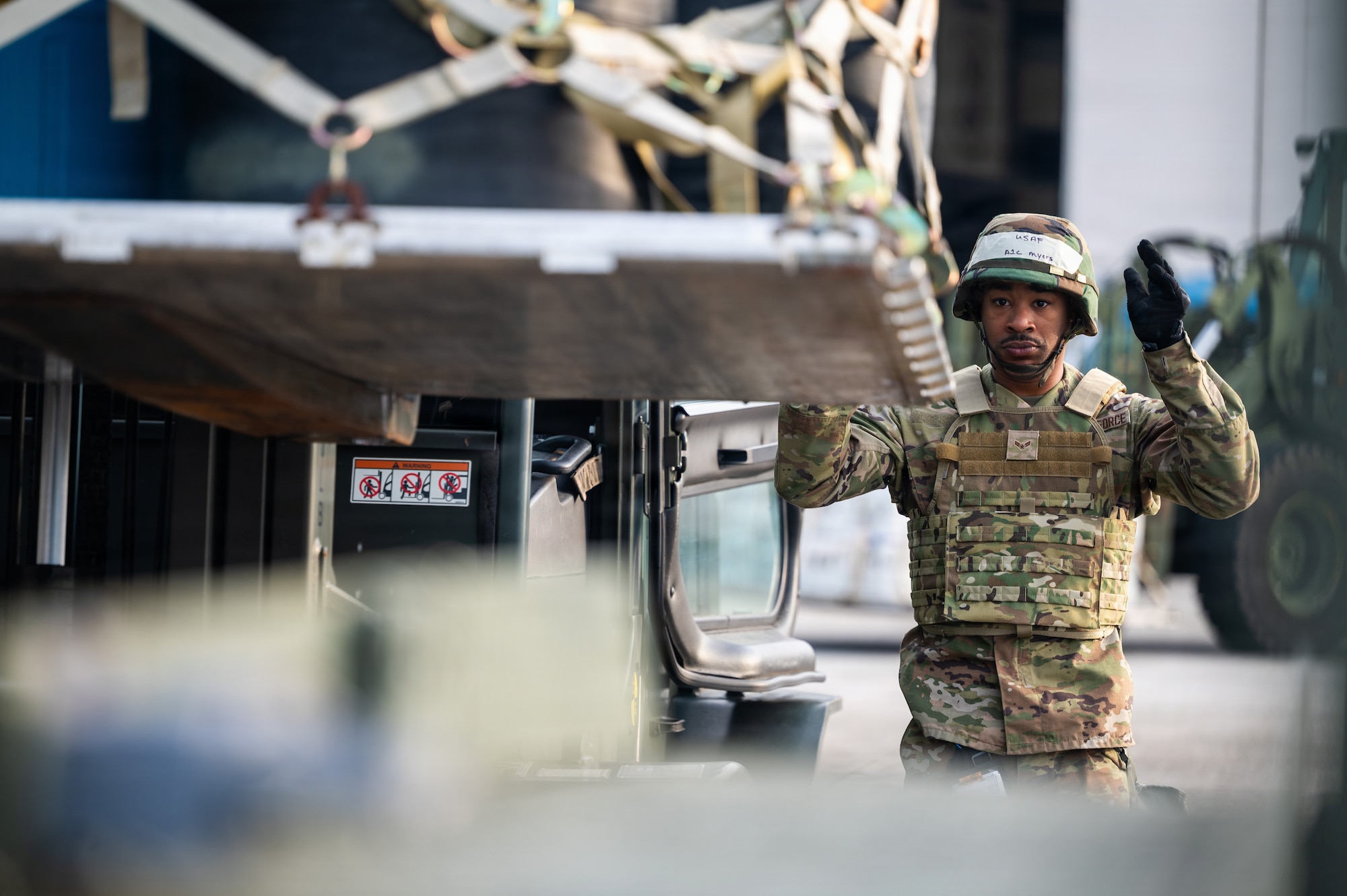 Airman directs forklift