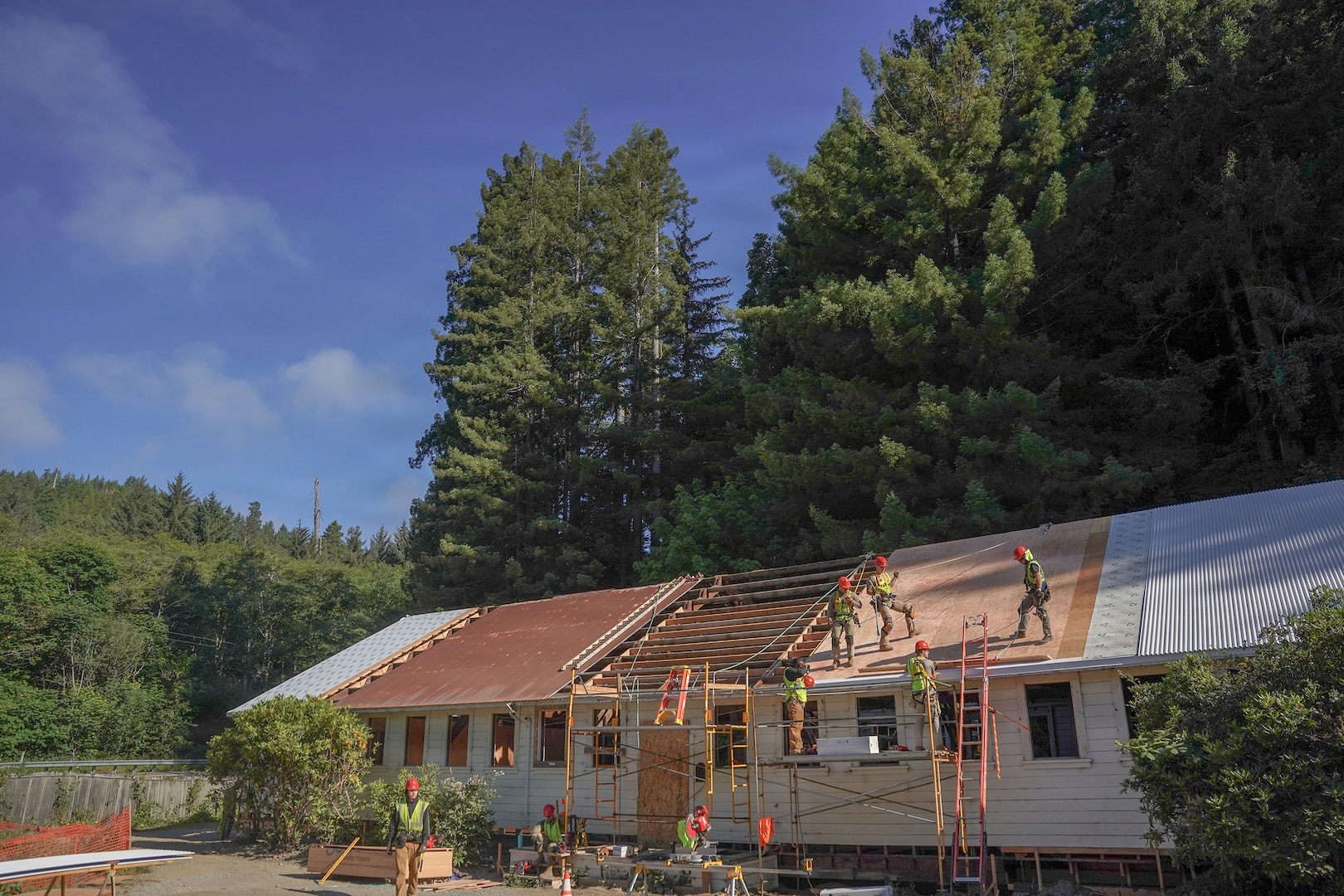 U.S. Airmen assigned to the 201st Rapid Engineer Deployable Heavy Operational Repair Squadron Engineers, 193rd Special Operations Wing and 111th Attack Wing, Pennsylvania Air National Guard, work on roof structures during an Innovative Readiness Training project at Redwood National and State Parks near Orick, California, July 17, 2026
