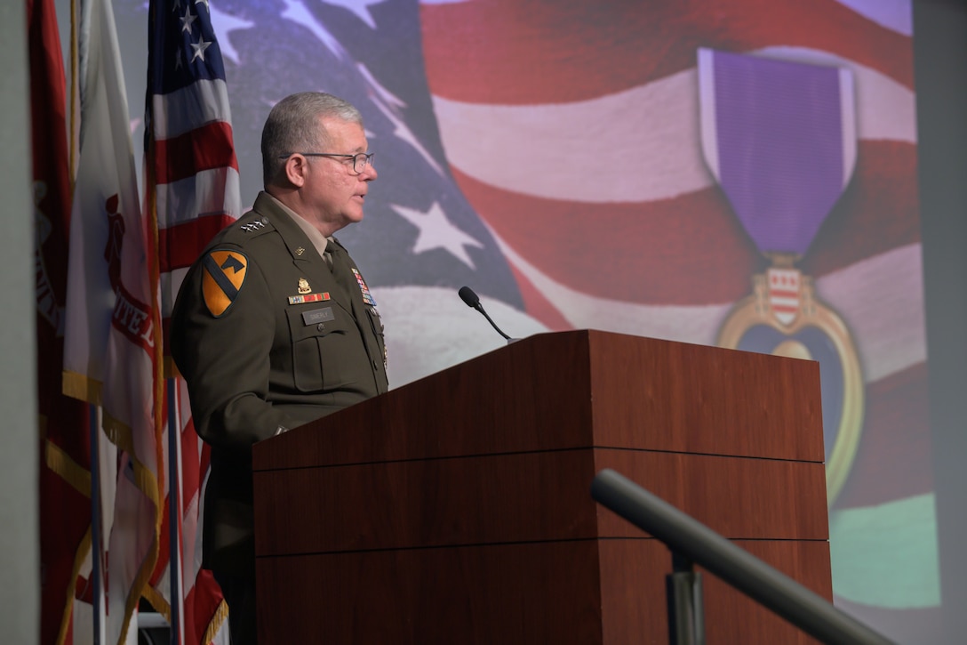 An Army general speaks at a podium during a ceremony.