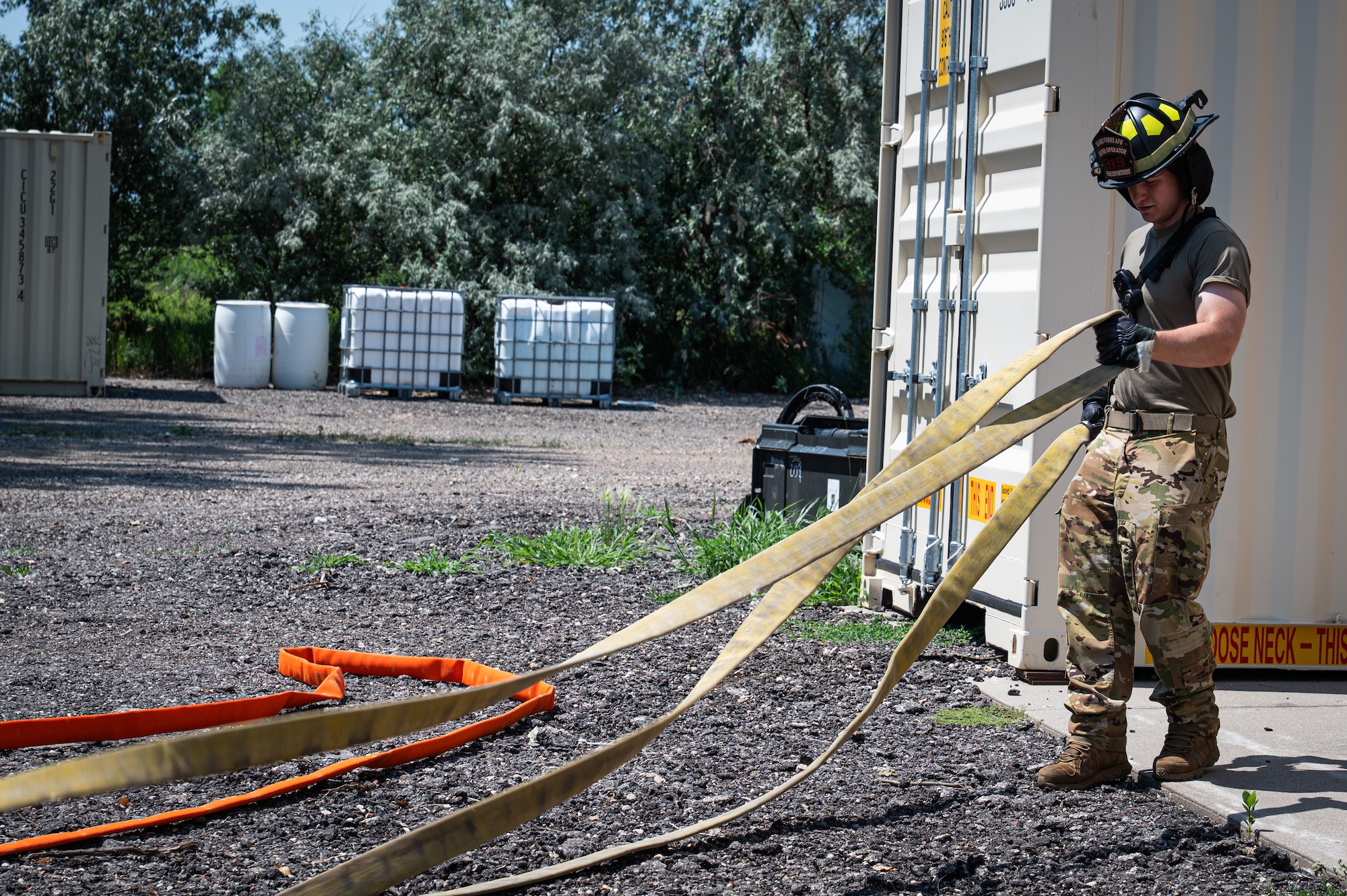 A photo of a firefighter untangling hoses.