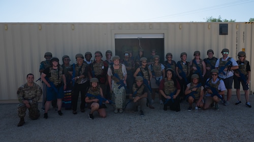 Educators pose for a group photo with U.S. Air Force recruiters during the Distinguished Educators’ Tour at the Joint All-Domain Expeditionary Forward Operations Readiness Generation Exercise (JADE FORGE) training grounds, Goodfellow Air Force Base, Texas, July 22, 2026. JADE FORGE is a simulated environment that provides intelligence, surveillance and reconnaissance warriors with a joint deployment training area. (U.S. Air Force photo by Senior Airman Brian Lummus)