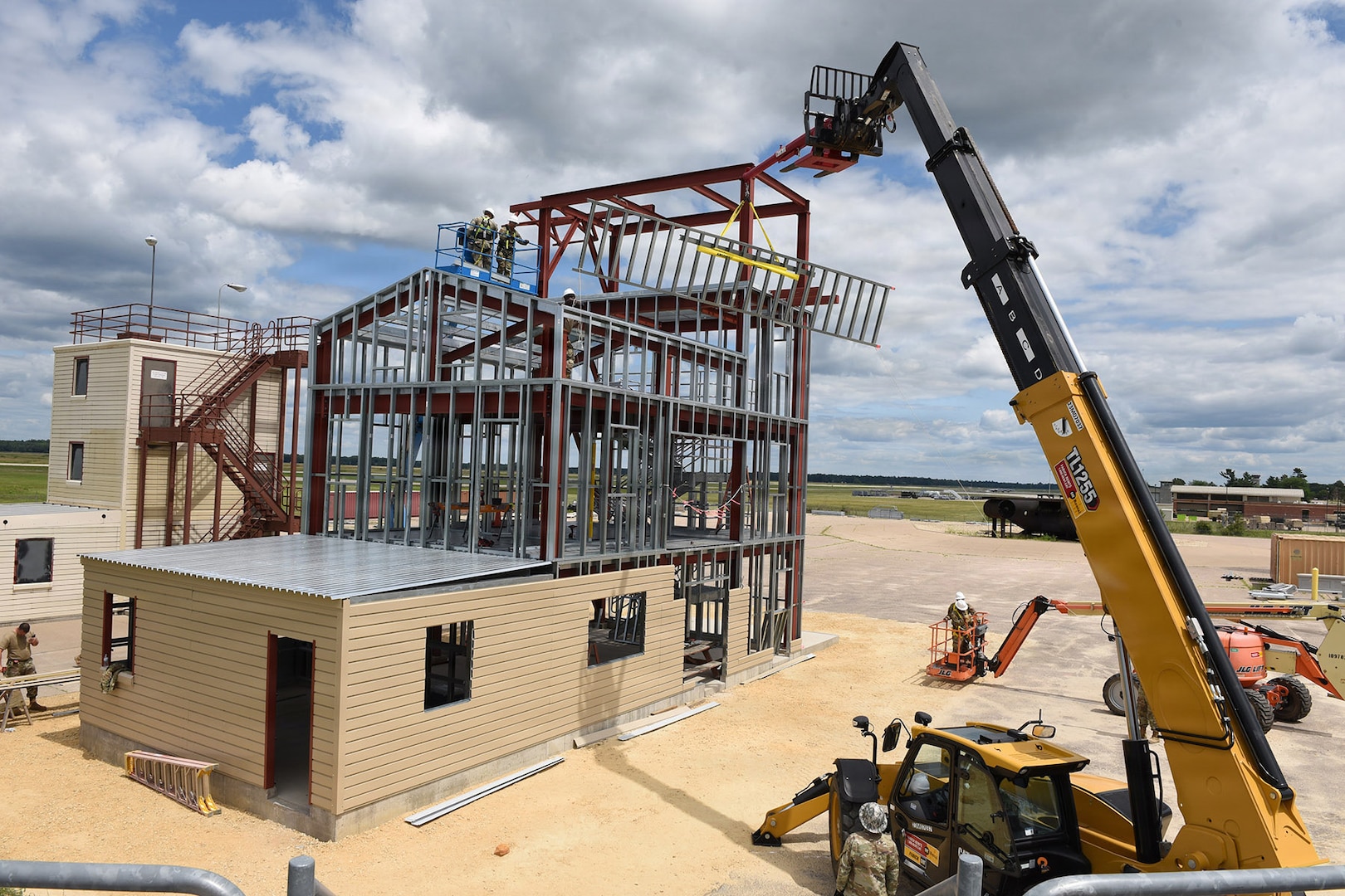 Airmen from the 159th Civil Engineering Squadron, Louisiana Air National Guard, erect a wall on the fourth floor of a fire training tower at Volk Field Combat Readiness Training Center, Camp Douglas, Wisconsin, July 22, 2026.