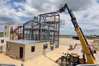 Airmen from the 159th Civil Engineering Squadron, Louisiana Air National Guard, erect a wall on the fourth floor of a fire training tower at Volk Field Combat Readiness Training Center, Camp Douglas, Wisconsin, July 22, 2026.