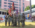 U.S. Army Col. William F. Bimson, right, director of Tripler Army Medical Center (TAMC), presents the unit colors to U.S. Army Command Sgt. Maj. Renee M. Butler, left, incoming command sergeant major of TAMC, during the change of responsibility ceremony at Constitution Park, July 29. (Defense Health Agency photo by Crizalmer Caraang Jr.)