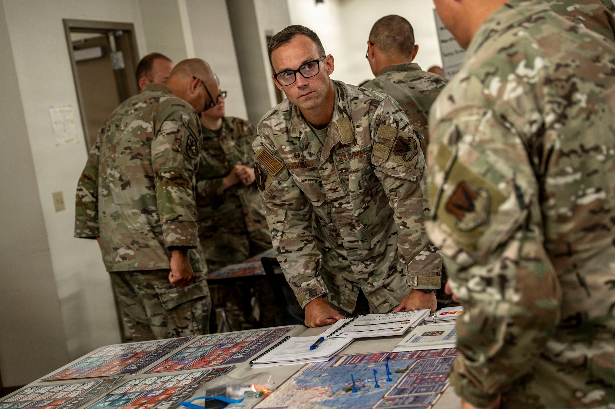 U.S. Air Force Airmen assigned to the 355th Wing work together during the Exercise Kingfish Ace portion of the Air Expeditionary Wing Command and Control course at Davis-Monthan Air Force Base, Arizona, July 22, 2026. Building integrated planning and coordination skills through AEWC2C strengthened readiness for future expeditionary operations. (U.S. Air Force photo by Airman 1st Class Samantha Melecio)