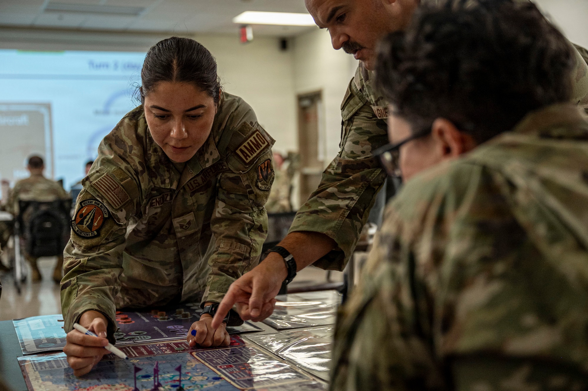 U.S. Air Force Airmen assigned to the 355th Wing work together during the Exercise Kingfish Ace portion of the Air Expeditionary Wing Command and Control course at Davis-Monthan Air Force Base, Arizona, July 22, 2026. Building integrated planning and coordination skills through AEWC2C strengthened readiness for future expeditionary operations. (U.S. Air Force photo by Airman 1st Class Samantha Melecio)