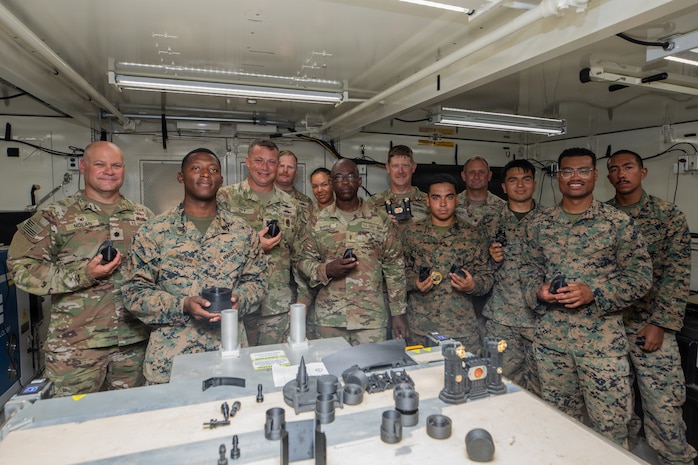 U.S. Marines with 3rd Maintenance Battalion, Combat Logistics Regiment 35, 3rd Marine Logistics Group, and Coast Guardsmen with Port Security Unit 309 pose for a group photo during a 3D printing capabilities showcase following Combined Joint Logistics Over-the-Shore 26 in Pohang, South Korea, July 17, 2026. The Marines demonstrated 3D printing capabilities to members of the Coast Guard’s Port Security Unit 309 as part of an effort to foster technological familiarization and strengthen joint logistical operations capabilities between Marines and Coast Guardsmen. CJLOTS 26 was a combined exercise designed to integrate U.S. and Republic of Korea lighterage and ship-to-shore connector capabilities, improve combined readiness, strengthen the Republic of Korea-U.S. alliance, and expand combined maritime sustainment capacity during logistics operations. (U.S. Marine Corps photo by Lance Cpl. Marcus Henson)
