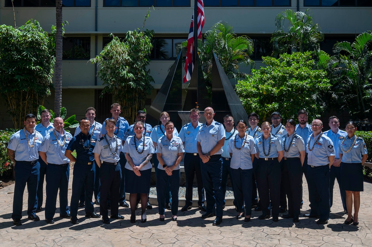 Multinational military members pose together for a group photo