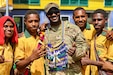Sgt. David Burgess, assigned to the 844th Engineer Battalion, poses with students from Igam Barracks Primary School during the closing ceremony for the ENCAP and health engagement at Igam Barracks in Lae, Papua New Guinea, July 22, 2026.